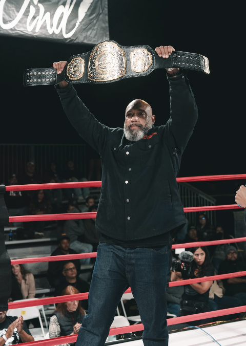 Lavar Johnson raising a championship belt in the ring