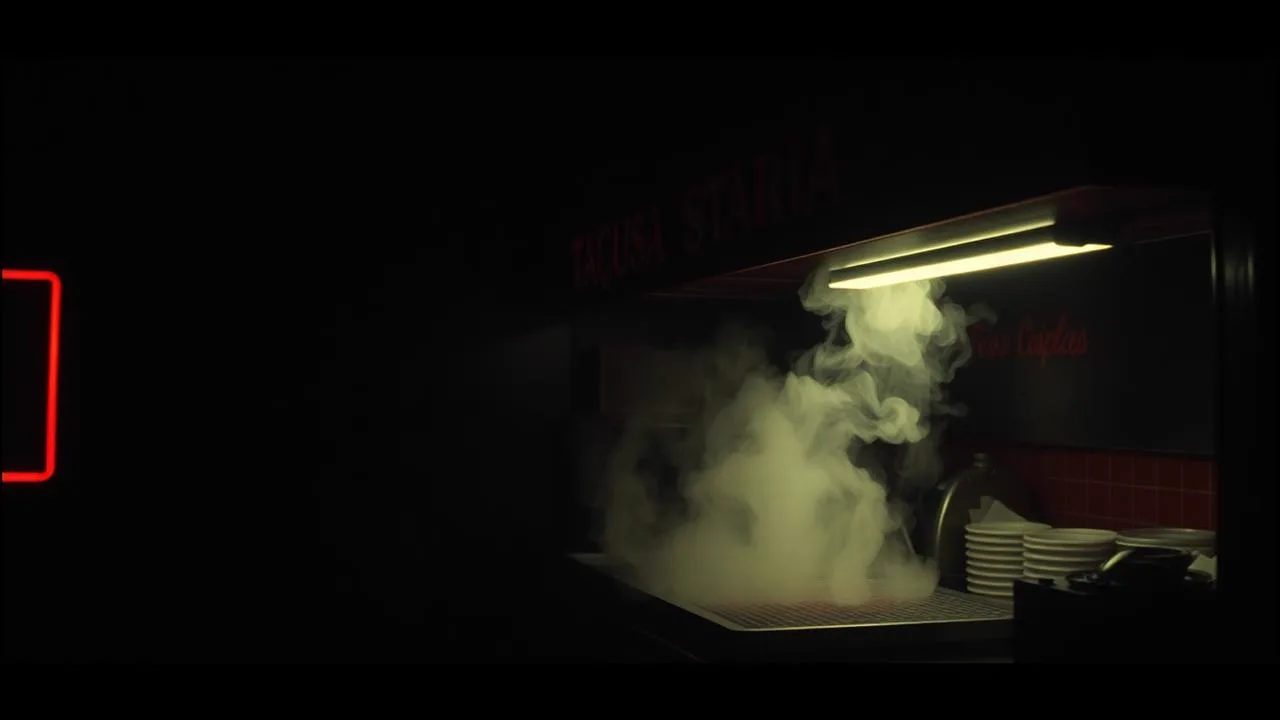 Steam rising from a griddle at a dark taqueria counter with warm overhead light